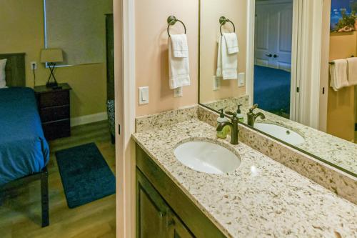a bathroom with a sink and a mirror at Red Desert Villa in Hurricane