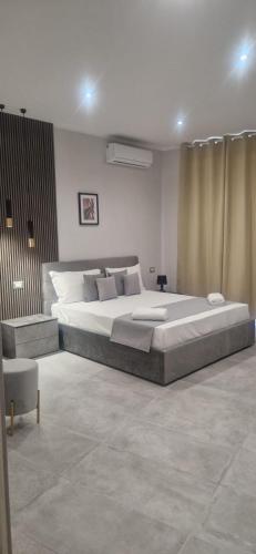 a large bedroom with a large bed and a chair at Hotel Movida in Casoria
