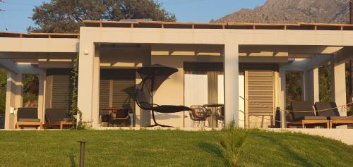 a house with a kite hanging off the side of it at Boutique apartments Myesis in Samothráki
