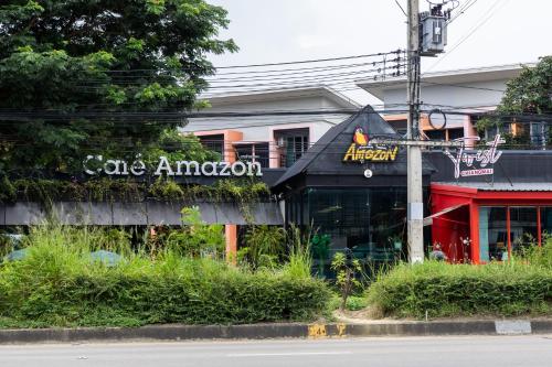 a cafe amazon sign on the side of a building at Cozy & Affordable apartment in Chiang Mai in Chiang Mai