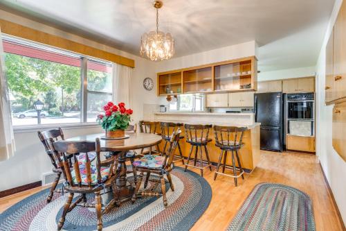 シーダーシティにある27 Mi to Zion Home with Backyard in Cedar City!のキッチン(木製のテーブル、椅子付)、大きな窓が備わります。