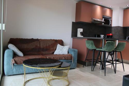 a living room with a couch and a table at Cosy 2p in Cagnes-sur-Mer