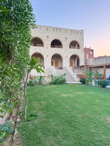 a building with a grass yard in front of it at كمبوند قرية تونس in Tunis