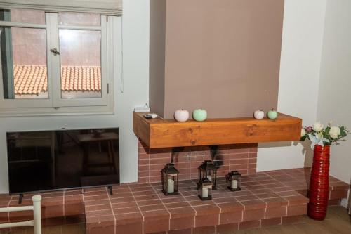 a brick fireplace with a wooden shelf above it at Portfront Neoclassical Gem in Lavrio in Lávrion