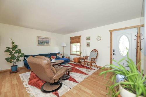 a living room with a chair and a couch at Sycamore Shade in Avon