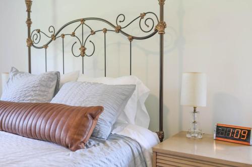 a bedroom with a bed and a table with a lamp at Sycamore Shade in Avon