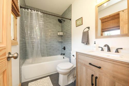 a bathroom with a tub and a toilet and a sink at Sycamore Shade in Avon