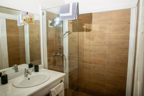 a bathroom with a sink and a shower at Portfront Neoclassical Gem in Lavrio in Lávrion