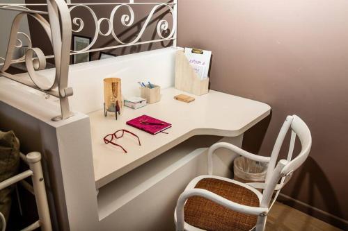 a white desk with a chair in a room at Portfront Neoclassical Gem in Lavrio in Lávrion
