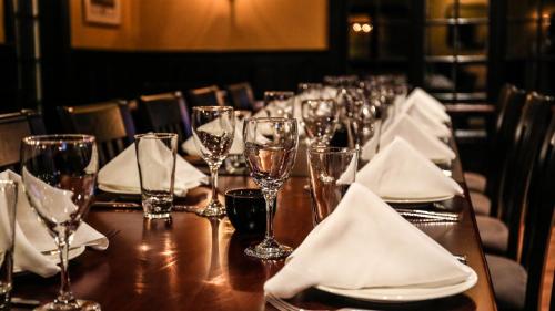 a long table with glasses and napkins on it at The Millerton Inn in Millerton