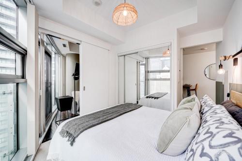 a bedroom with a white bed and a window at Best Downtown Toronto View! in Toronto