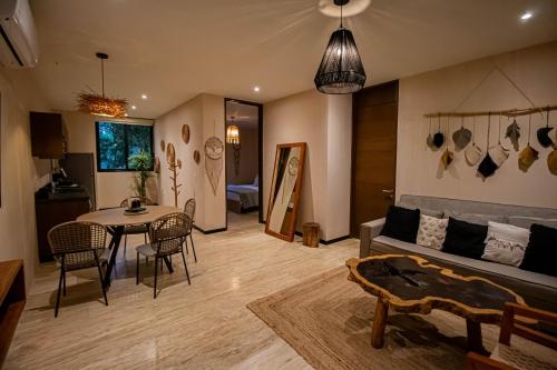 a living room with a couch and a table at Ophelia Experience in Tulum