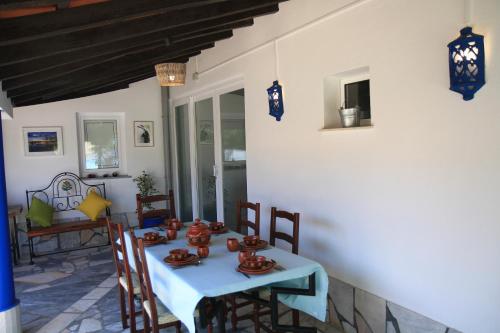 a dining room with a blue table and chairs at Casa dos Avós in Monsaraz