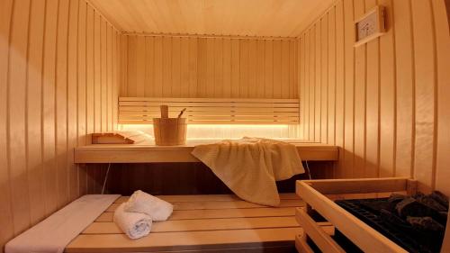 a room with a sauna with a table and towels at Résidence Le Bettex - Chalet EDELWEISS MAE-9614 in Praranger