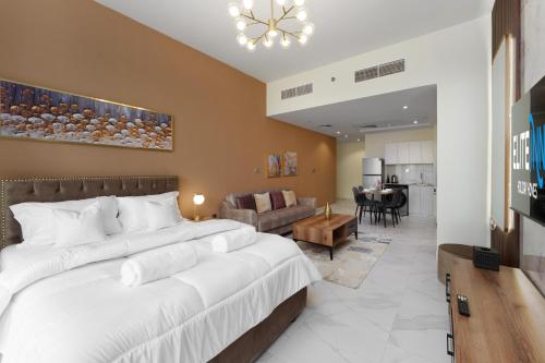 a bedroom with a large bed and a living room at Business Bay Gem , Burj Khalifa View in Dubai