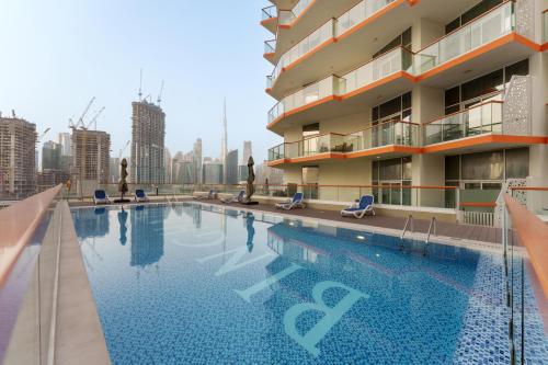 a swimming pool on the roof of a building at Business Bay Gem , Burj Khalifa View in Dubai