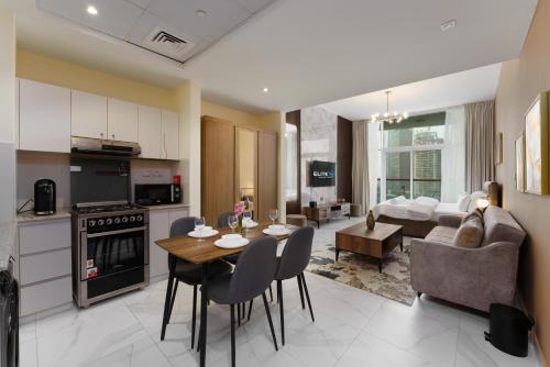 a kitchen and living room with a table and chairs at Business Bay Gem , Burj Khalifa View in Dubai