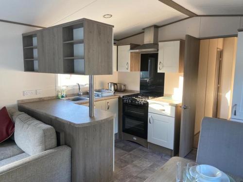 a kitchen with a sink and a counter top at Kiln Park in Tenby