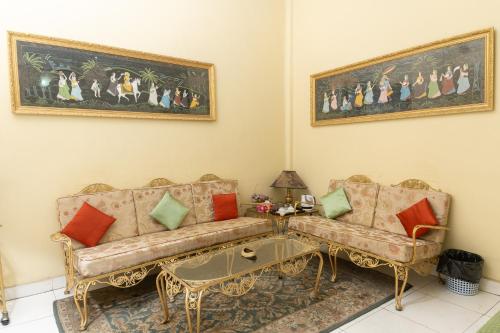 a living room with a couch and a table at Baruah Bhavan Homestay in Guwahati