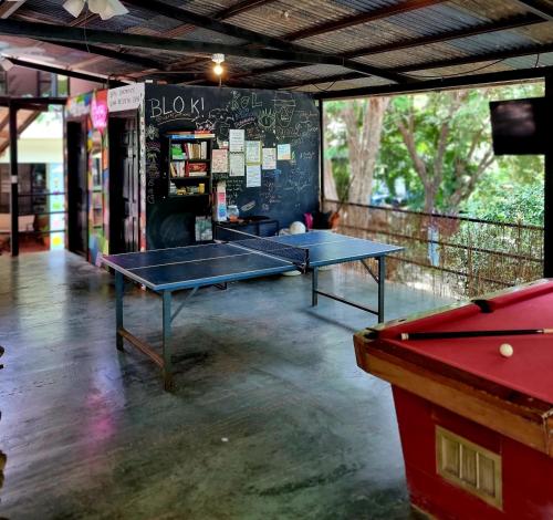 two ping pong tables in a ping pong room at Casa Pura Vida Surf Hostel - Tamarindo Costa Rica in Tamarindo
