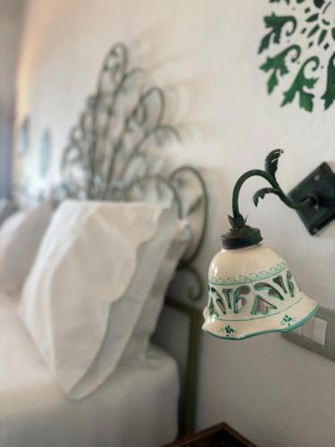 a lamp sitting on the side of a bed at Villa La Rosa in Filicudi