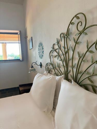 a bedroom with a white bed with a large floral headboard at Villa La Rosa in Filicudi