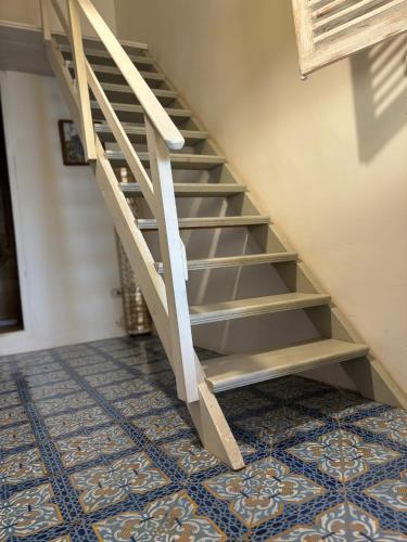 a staircase in a room with a tile floor at Villa La Rosa in Filicudi