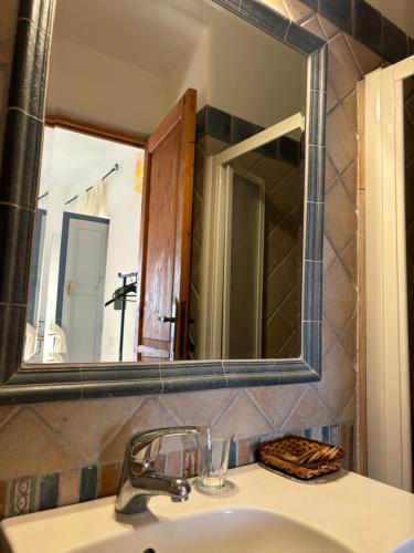 a bathroom with a sink and a mirror at Villa La Rosa in Filicudi