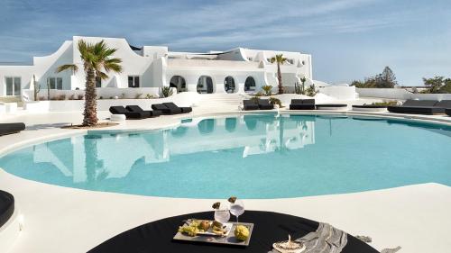 a swimming pool in front of a villa at Million Stars Mykonos in Mýkonos City