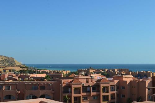 a view of a city with houses and the ocean at Pearl Surf Camp Morocco in Agadir
