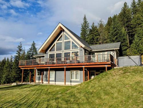 a house on top of a grassy hill at Leavenworth Mountain View Alpine Escape in Leavenworth