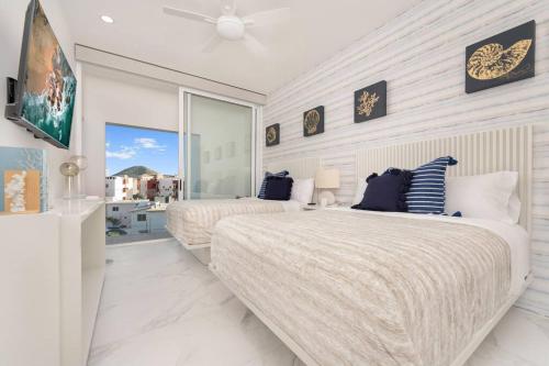 a bedroom with two beds and a large window at New Condo With 2BR in San Lucas in Cabo San Lucas