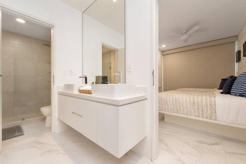 a white bathroom with a sink and a bed at New Condo With 2BR in San Lucas in Cabo San Lucas