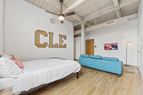 a bedroom with a bed and a blue couch at 306-Urban Blissful Oasis Close to DT Parking in Cleveland