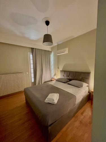 a bedroom with a large bed in a room at Comfort and Sunny Apartment, Marousi OAKA Stadium Neratziotissa in Athens