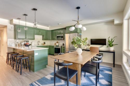 a kitchen with green cabinets and a wooden table and chairs at Condo in Government Camp in Government Camp