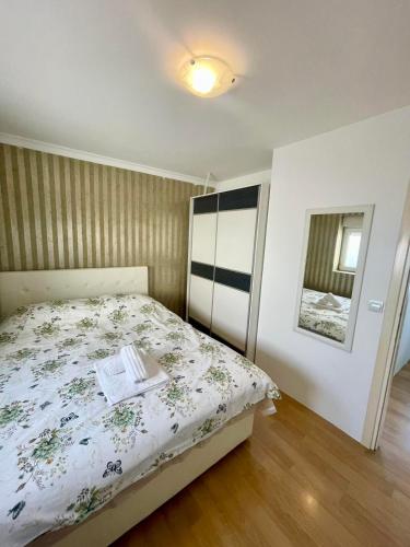 a bedroom with a bed with a book on it at City center 34 in Podgorica