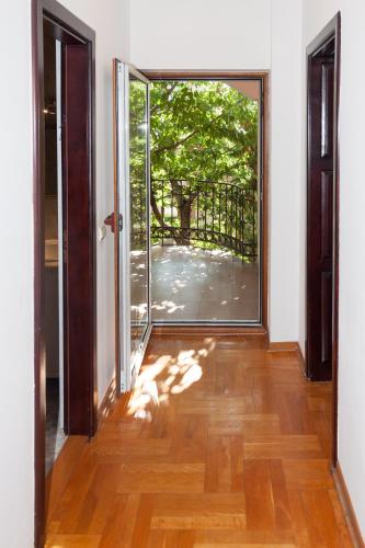 an empty room with an open door to a patio at Red Clay Apartments City Club in Belgrade