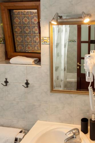a bathroom with a sink and a mirror at Red Clay Apartments City Club in Belgrade
