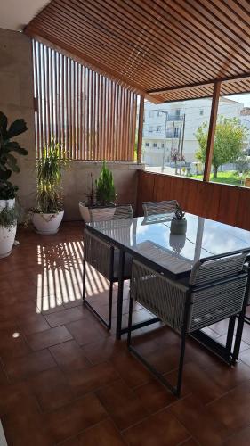 a table and two chairs on a patio at Pombal Suite in Pombal