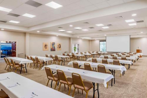 an empty room with tables and chairs and a whiteboard at Best Western Plus Crossroads Inn & Suites in Zion Crossroads