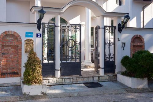 an entrance to a house with a black gate at Red Clay Apartments City Club in Belgrade