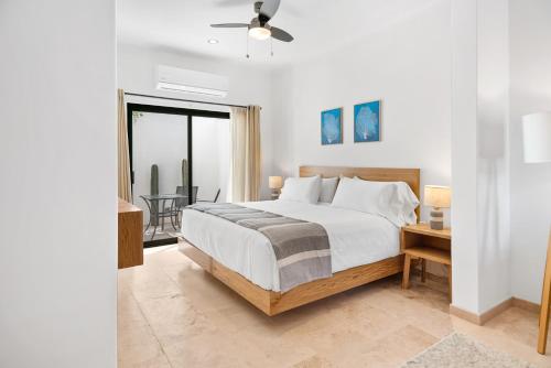 a bedroom with a large bed and a balcony at Pineda Suite #102 two blocks from the Malecon in La Paz