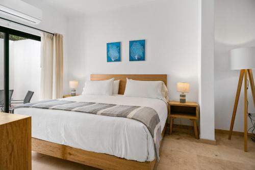 a bedroom with a large bed and a window at Pineda Suite #102 two blocks from the Malecon in La Paz