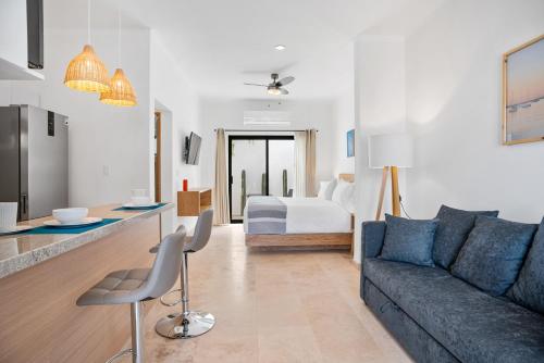 a living room with a couch and a bed at Pineda Suite #102 two blocks from the Malecon in La Paz