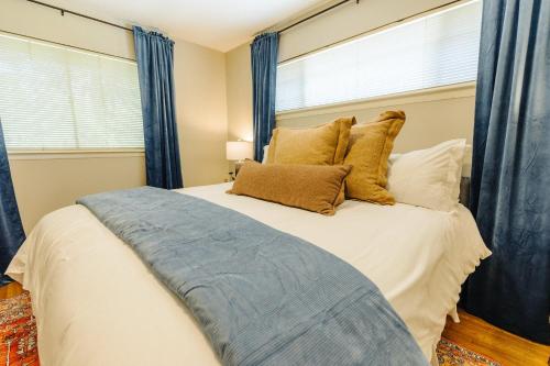 a bedroom with a large bed with blue curtains at Centrally Located 2 King Bed Midtown Memphis 2362 in Memphis