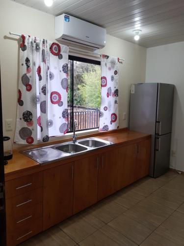a kitchen with a sink and a refrigerator at Apartamento Hohenau Centro in Hohenau