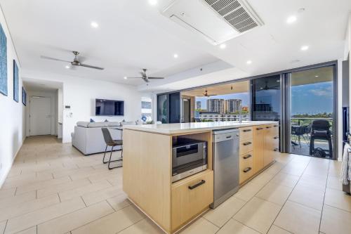 an open kitchen with a view of a living room at Darwin Waterfront Short Stay Apartments in Darwin