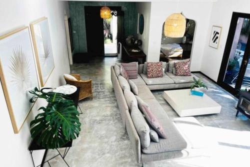 a living room with a couch and a table at Luxe Thirroul Home, Pool Spa Home Theatre in Thirroul