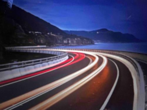 a long exposure photo of a highway at night at Luxe Thirroul Home, Pool Spa Home Theatre in Thirroul